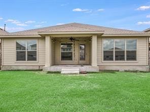 rear view of property featuring a yard