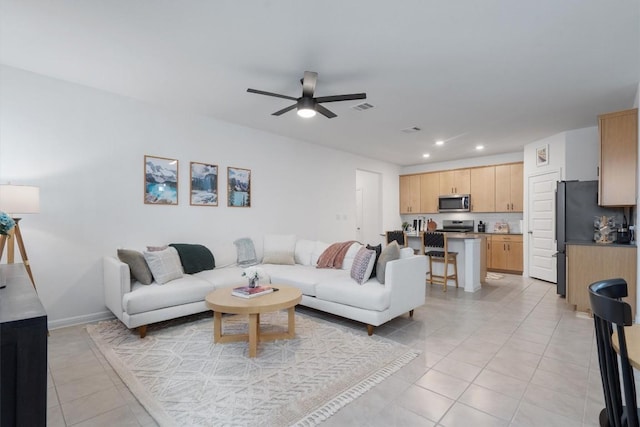 living room with light tile patterned floors and ceiling fan