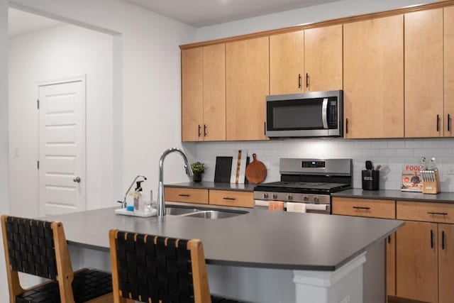 kitchen with tasteful backsplash, sink, stainless steel appliances, and light brown cabinets