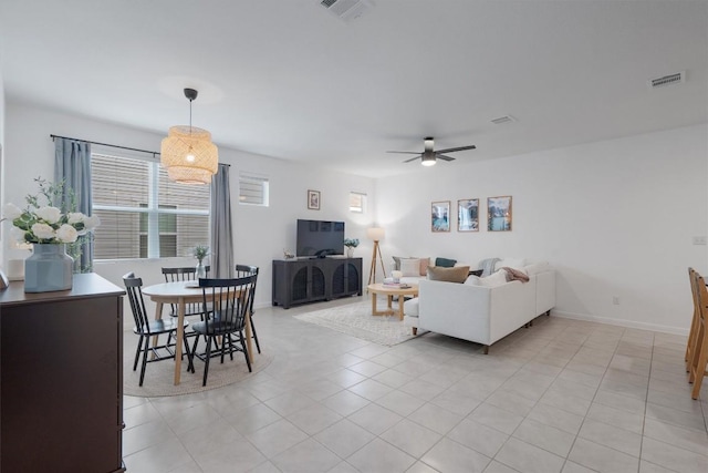 tiled living room with ceiling fan