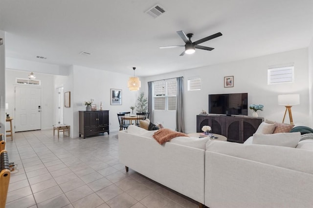 living room with light tile patterned floors and ceiling fan