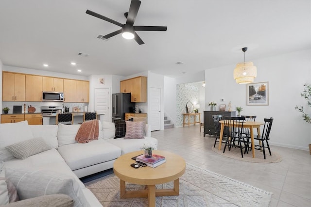 tiled living room with ceiling fan