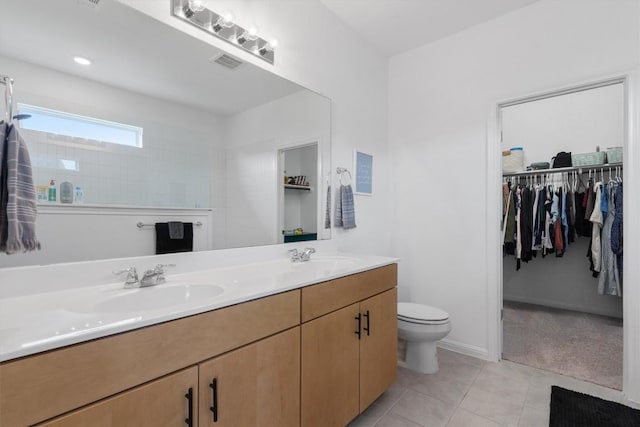 bathroom with vanity, toilet, and tile patterned flooring