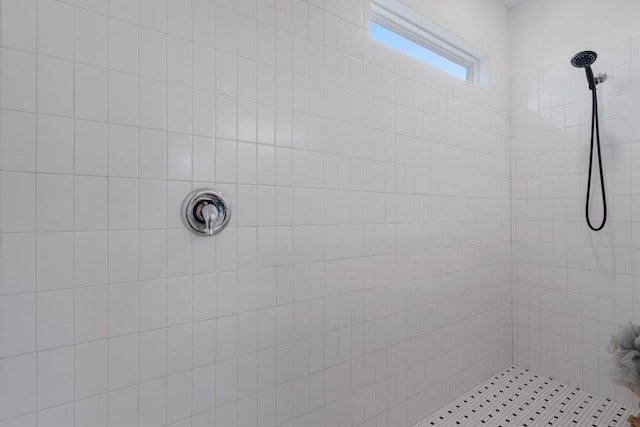 bathroom with a tile shower