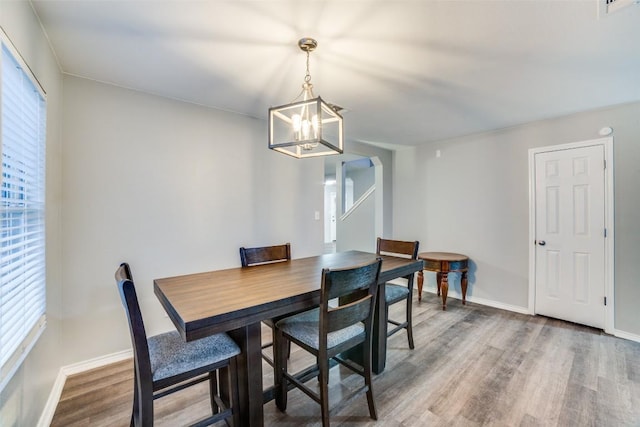 dining room featuring hardwood / wood-style flooring, plenty of natural light, and a chandelier