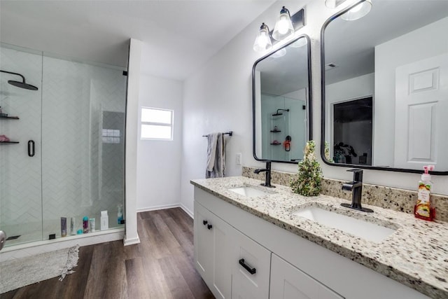 bathroom featuring a shower with door, wood-type flooring, and vanity