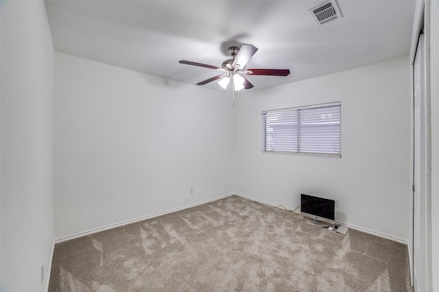 unfurnished room featuring light carpet and ceiling fan