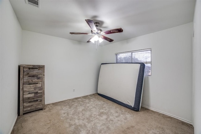 unfurnished bedroom with light colored carpet and ceiling fan