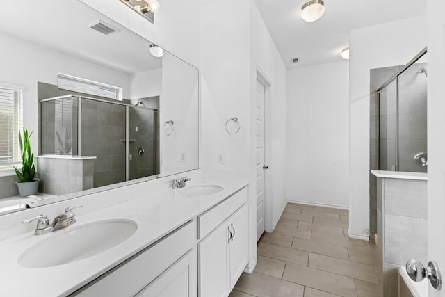 11813 Carrizo Springs Path, Manor, TX 78653 - full bath featuring double vanity, a stall shower, and tile patterned floors
