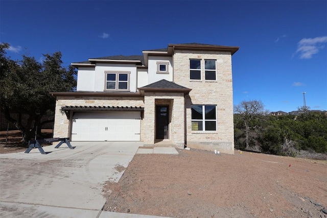 view of front facade with a garage, stone siding, and driveway