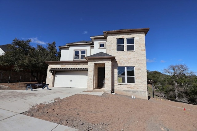 view of front of house with concrete driveway, a garage, and stone siding