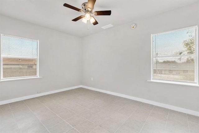 spare room with a healthy amount of sunlight and ceiling fan