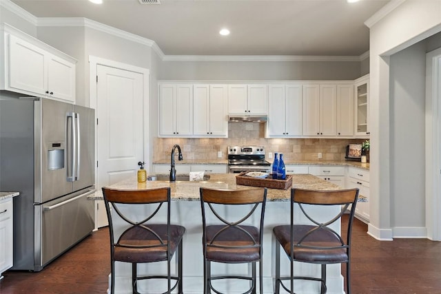 216 Fairlake Cir, Austin, TX 78734 - kitchen featuring appliances with stainless steel finishes, under cabinet range hood, dark wood-style flooring, white cabinetry, and tasteful backsplash