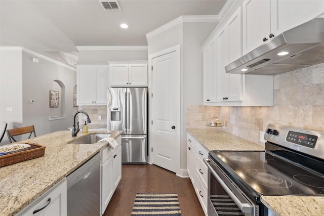 216 Fairlake Cir, Austin, TX 78734 - kitchen with stainless steel appliances, under cabinet range hood, crown molding, white cabinetry, and dark wood-type flooring