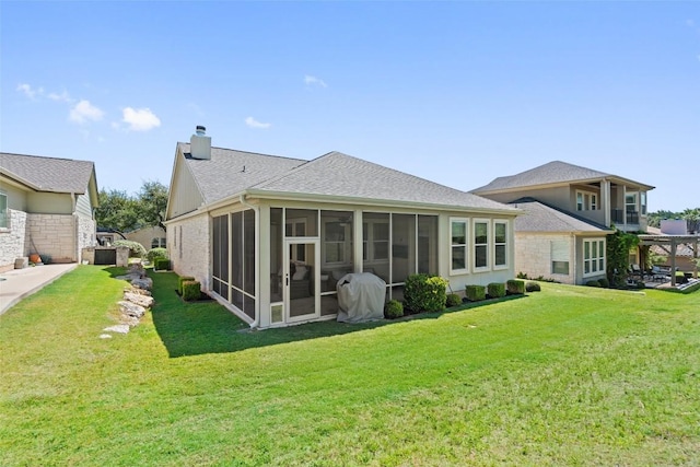 216 Fairlake Cir, Austin, TX 78734 - rear view of property featuring a sunroom, a chimney, a yard, and roof with shingles