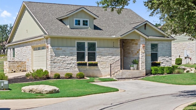 view of front of property featuring a garage and a front yard