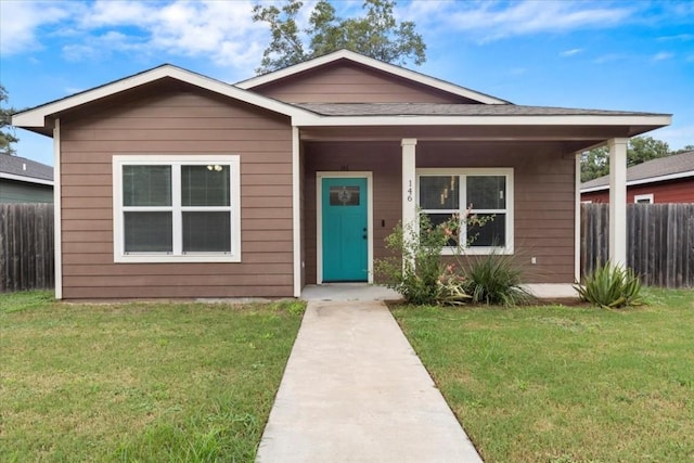 bungalow with fence, a porch, and a front yard