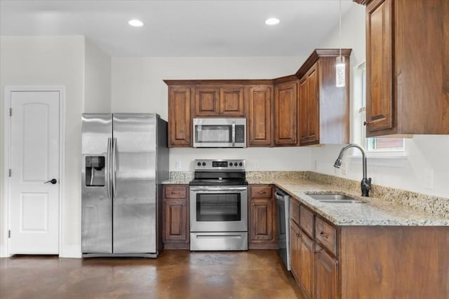 kitchen with light stone counters, stainless steel appliances, and sink