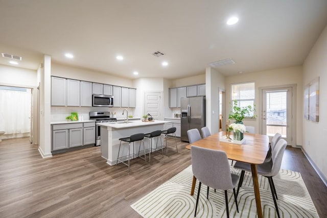 dining area with hardwood / wood-style flooring and sink