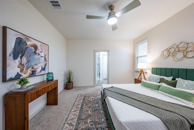 carpeted bedroom featuring ceiling fan and ensuite bath