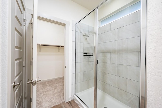 bathroom with a shower with door