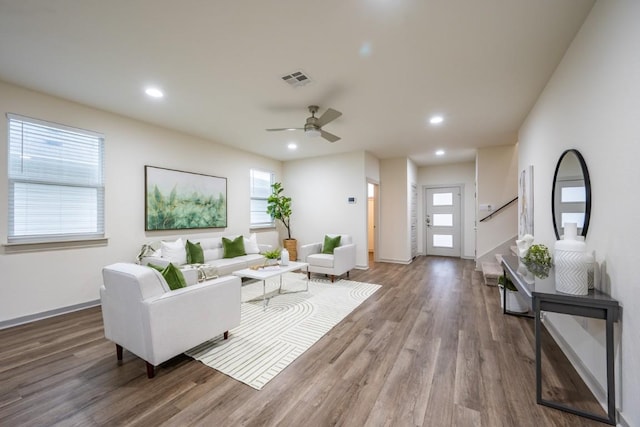 living room with hardwood / wood-style flooring, a wealth of natural light, and ceiling fan