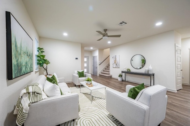 living room with ceiling fan and light wood-type flooring