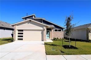 view of front of home featuring a garage and a front yard