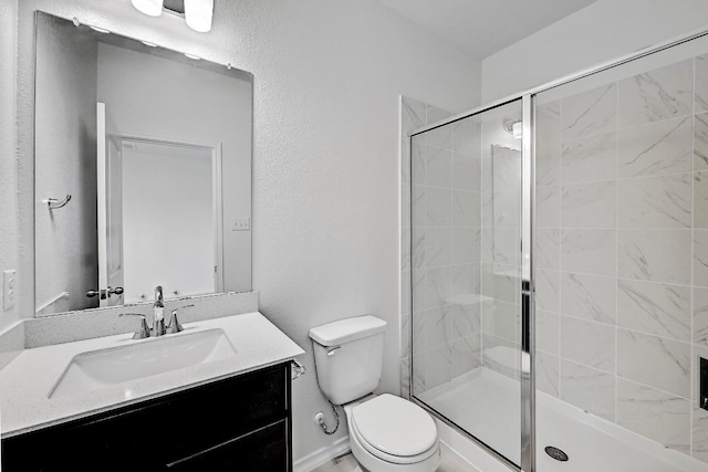 full bath featuring a stall shower, toilet, and vanity