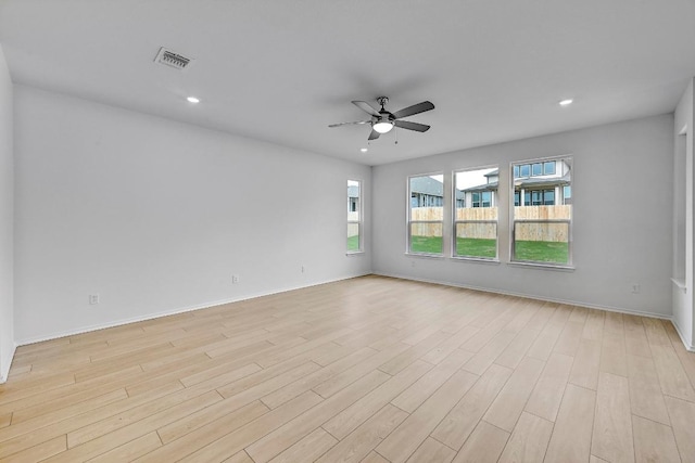 empty room with visible vents, light wood-style flooring, ceiling fan, and recessed lighting