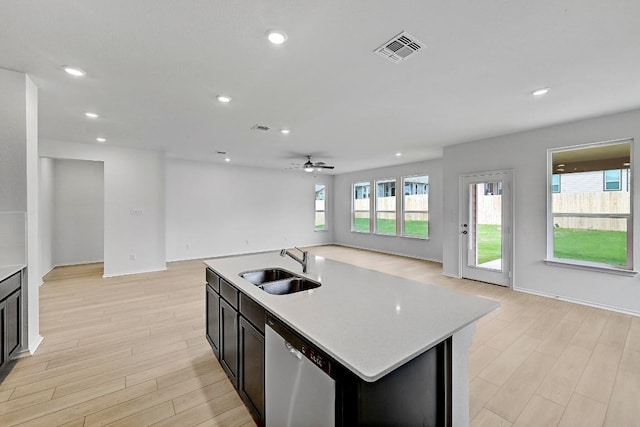 kitchen with visible vents, dishwasher, a sink, light wood-type flooring, and open floor plan