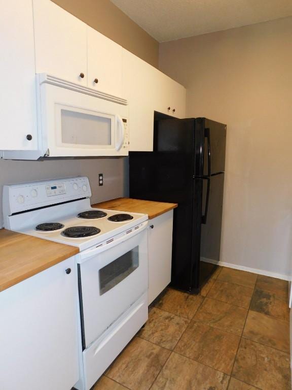 kitchen featuring white cabinetry and white appliances