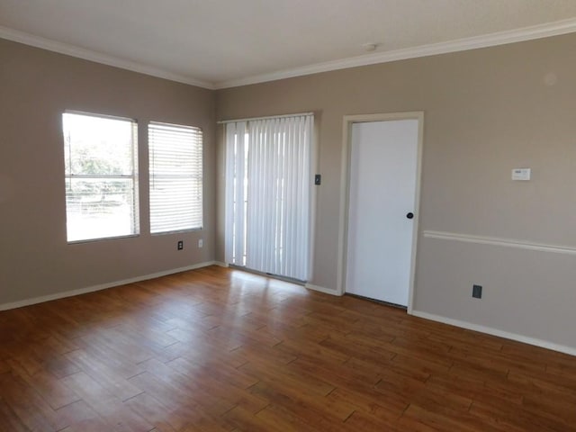 spare room with ornamental molding and hardwood / wood-style floors