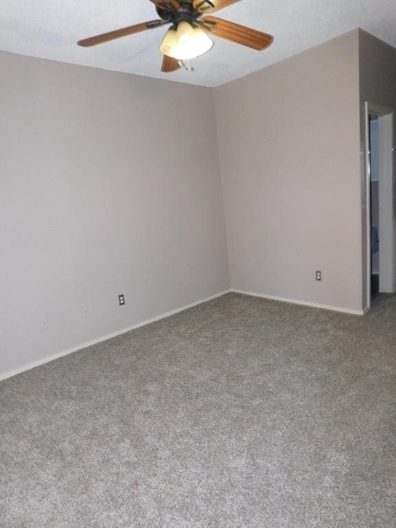 spare room with carpet floors and ceiling fan