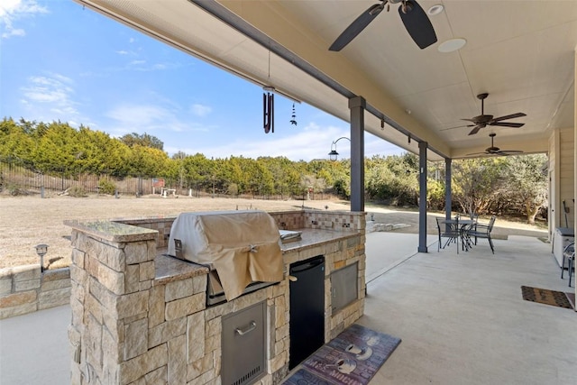 view of patio / terrace with exterior kitchen, ceiling fan, and grilling area