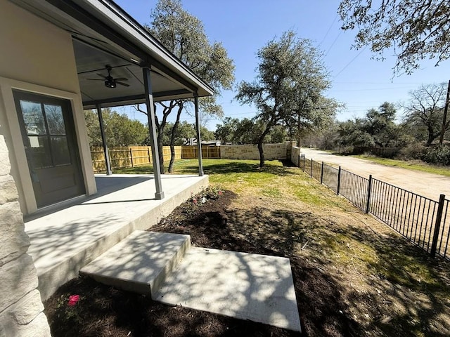 view of yard featuring a fenced backyard and a ceiling fan