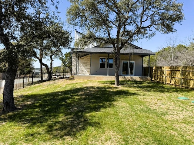 18208 Gregg Bluff Rd, Jonestown, TX 78645 - back of house with stucco siding and a fenced backyard