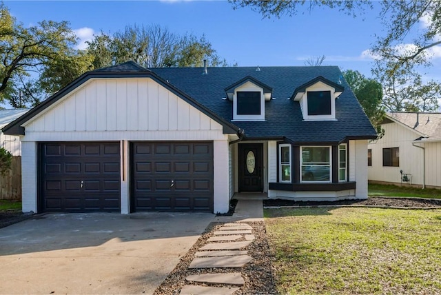 3507 Lovage Dr, Austin, TX 78727 - view of front of house with a shingled roof, driveway, a garage, a front yard, and board and batten siding
