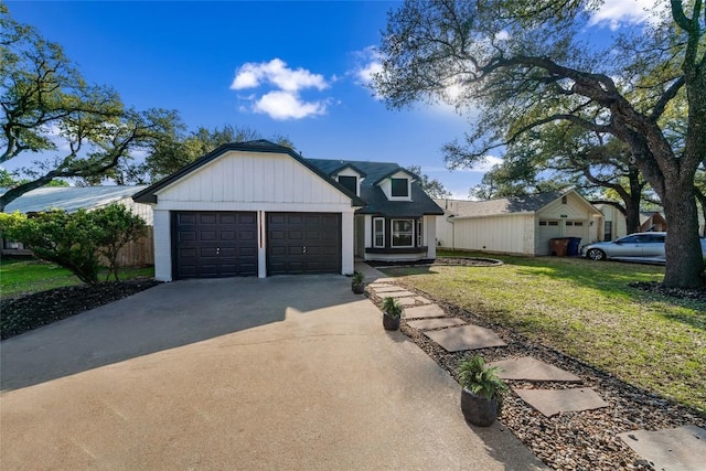 3507 Lovage Dr, Austin, TX 78727 - modern farmhouse style home featuring driveway, an attached garage, and a front yard