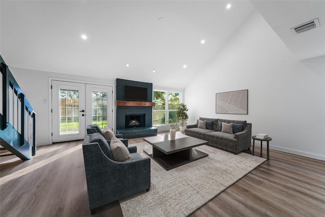 3507 Lovage Dr, Austin, TX 78727 - living area featuring high vaulted ceiling, french doors, wood finished floors, recessed lighting, and a large fireplace