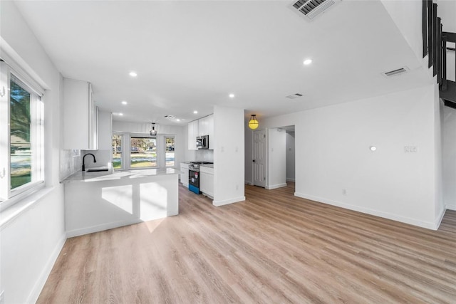 3507 Lovage Dr, Austin, TX 78727 - unfurnished living room featuring recessed lighting and light wood-style flooring