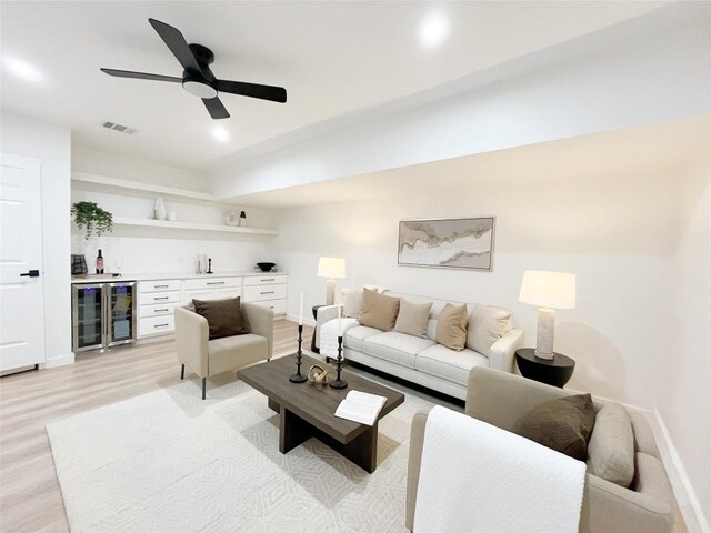3507 Lovage Dr, Austin, TX 78727 - living room featuring beverage cooler, bar, light wood-style floors, and ceiling fan