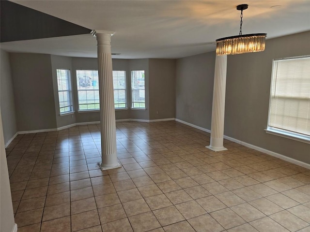 tiled spare room with decorative columns