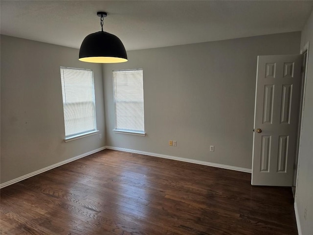 unfurnished room with dark wood-type flooring