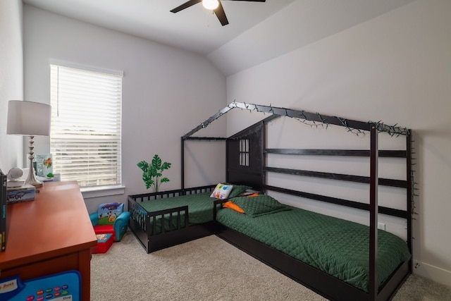 carpeted bedroom featuring vaulted ceiling and ceiling fan