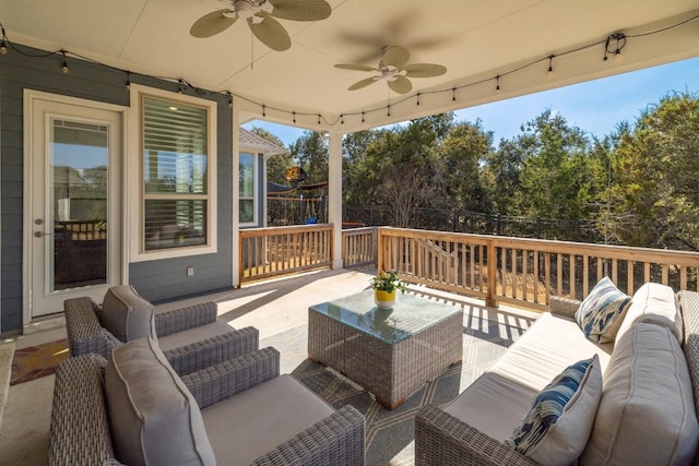 wooden deck with ceiling fan, an outdoor living space, and fence