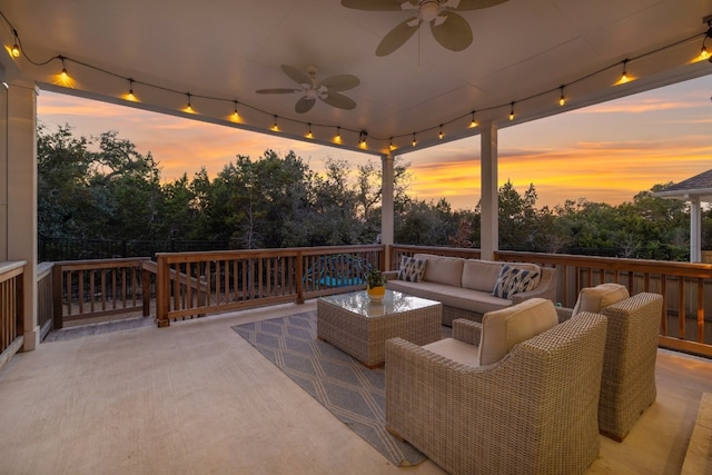 view of patio / terrace with a ceiling fan, a fenced backyard, and an outdoor living space