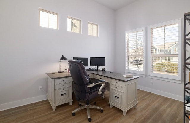 home office featuring baseboards and light wood-style floors