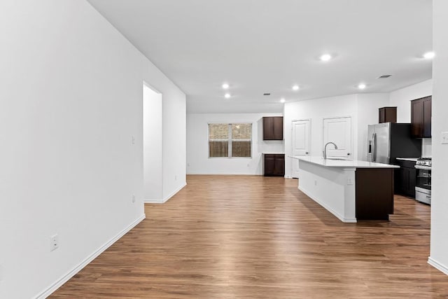 3201 Fresh Spring Rd, Pflugerville, TX 78660 - kitchen with stainless steel appliances, a sink, wood finished floors, and recessed lighting