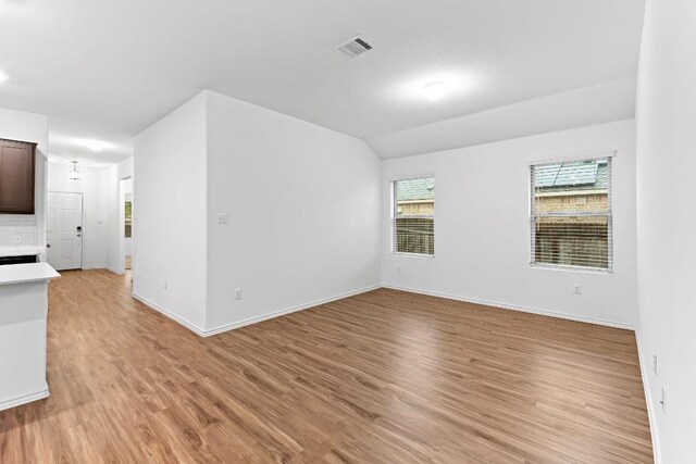 3201 Fresh Spring Rd, Pflugerville, TX 78660 - empty room with light wood-type flooring, baseboards, and lofted ceiling